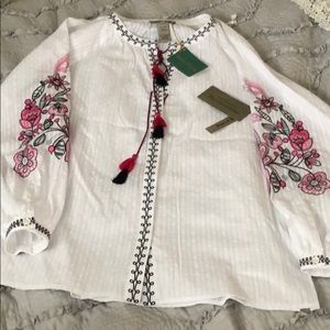 White blouse with pink embroidered detail